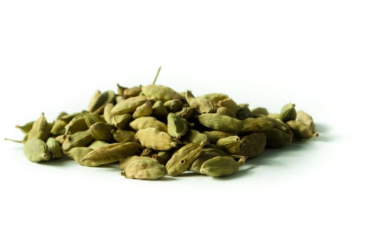 Pile of whole cardamom on white background
