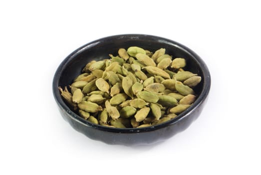 Pile of whole cardamom on white background