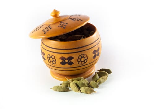 Pile of whole cardamom on white background