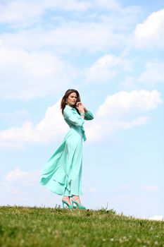 Portrait in full growth, attractive young woman in green dress