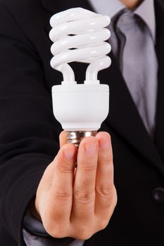 Business woman with smart suit holding and showing white economic light bulb