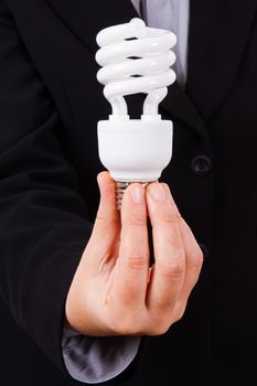 Business woman with smart suit holding and showing white economic light bulb