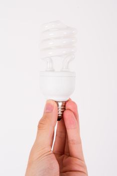 Affordable light bulb holding by male human hand on white.