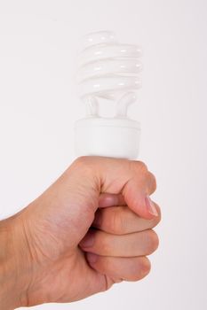 Affordable light bulb holding by male human hand on white.