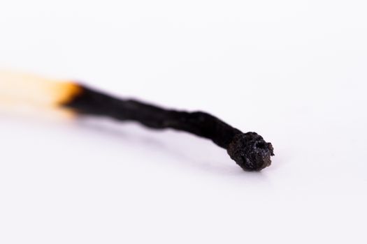 Macro view of burnt matches with depth of field, isolated on white background.