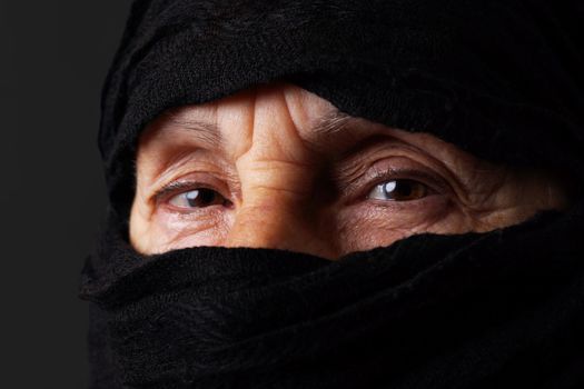 Eyes of senior muslim woman with niqab, looking at camera