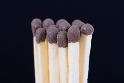 Group of healthy matches on dark background.