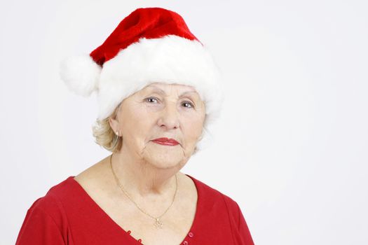 Beautiful senior woman with Santa Claus Christmas hat
