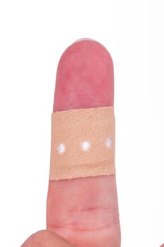 Close up view of adhesive bandage, plaster on index finger, isolated on white background.