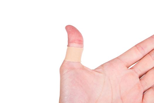 Adhesive bandage, plaster on thumb, isolated on white background.