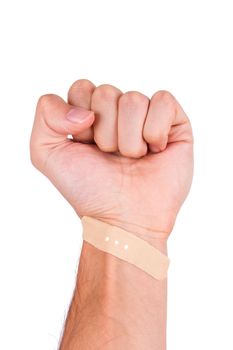 Adhesive bandage, plaster on wrist of punch hand, isolated on white background.
