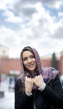 Portrait of young happy woman in red scarf