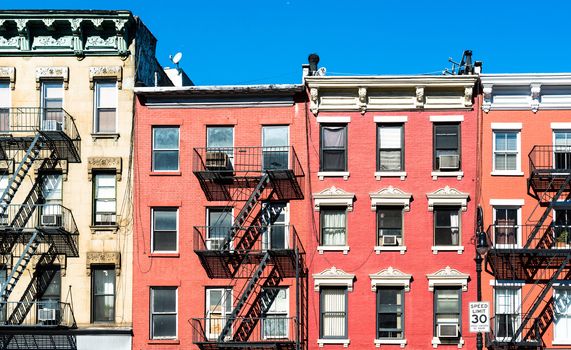 fire laddesrs at beautiful colorful house facades downtown in New York