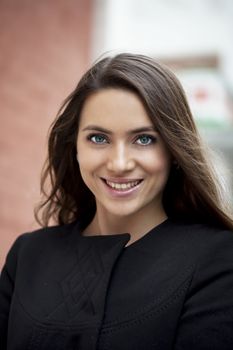 Portrait of beautiful woman in autumn street