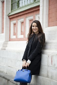 Portrait of beautiful woman in autumn street