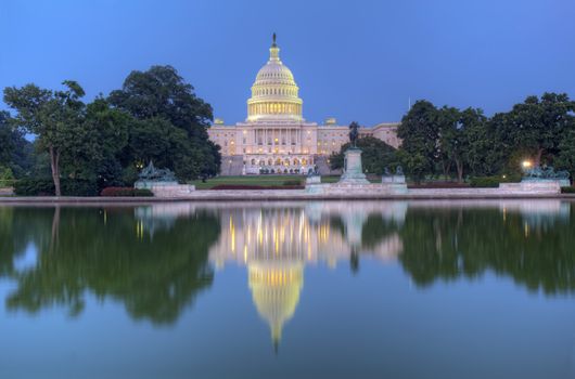 HDR image of the west side of the United States Capitol building and Ulysses S Grant memorial reflected in the reflecting pool just after sunset