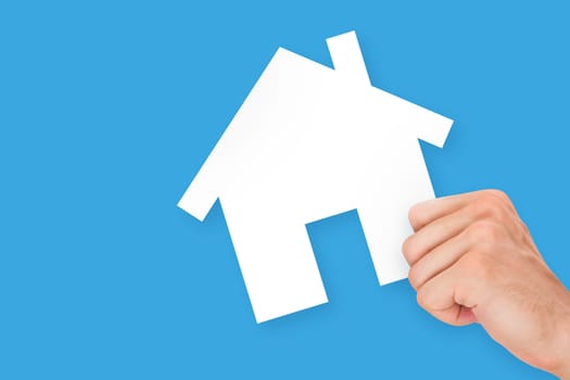 Hand holding white, empty, blank real estate cardboard, isolated on blue background.