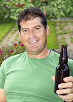 Middle aged man enjoying a cold beer outdoor