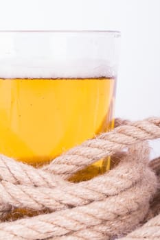 Full of beer glass and rope, isolated on white background.