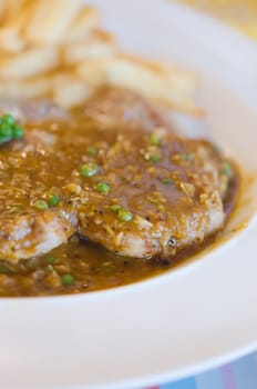  beef  steak with green peppercorn sauce served with chips ( selective focus)