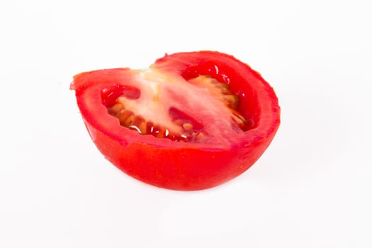 Red tomato vegetable with cut, isolated on white background.