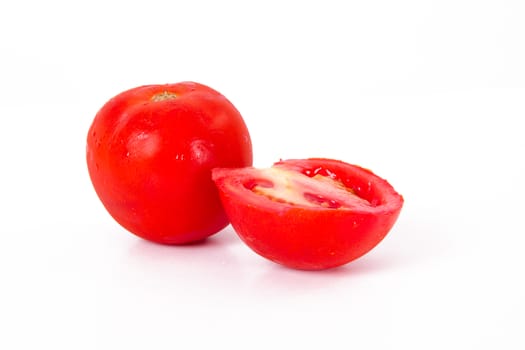 Red ripe tomato and cutted tomato, isolated on white background.