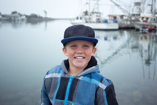 Happy Boy Sitting Harborside