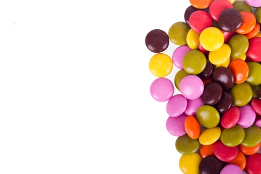 Colorful sugar candies with copy space, isolated on white background.