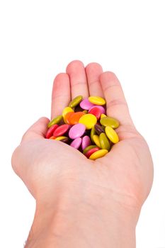 Hand reaching little colorful sugar candies, isolated on white background.