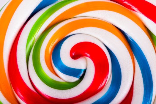 Colorful spiral lollipop candy as background.