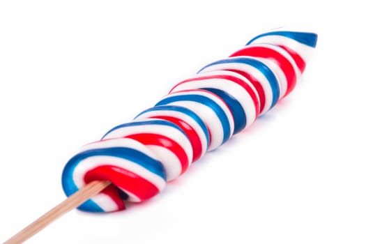 Colorful spiral lollipop candy on stick, isolated on white background.