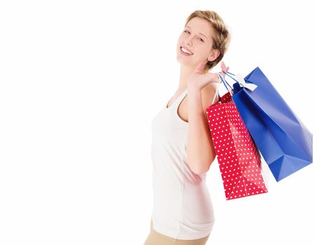 happy blonde woman with shopping bags on white background