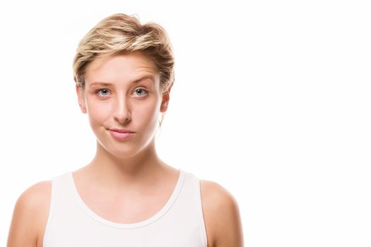 young blonde woman lifting eyebrow on white background
