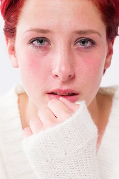 sadly depressed crying young redhead woman with tears in her eyes