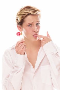 young woman holding lollipop sucking her finger on white background