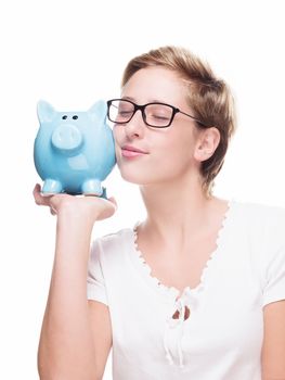 cute blonde woman cuddling with a piggy bank on white background