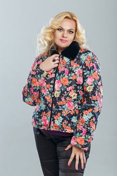 Adult woman in a warm jacket, photographed in the studio