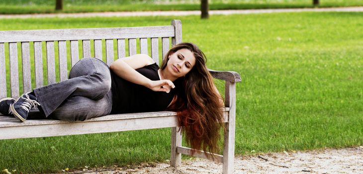 pretty young girl couch on a bench
