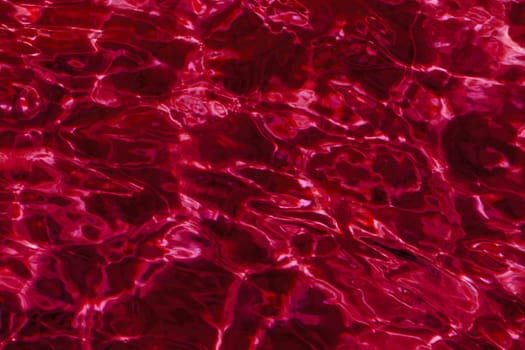 red abstract background of wavy water surface