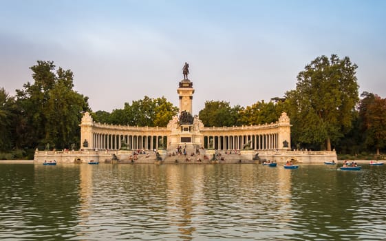 Buen Retiro park lake in Madrid with monument to Alfonso XII on the background
