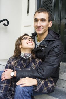 Portrait of love couple embracing outdoor looking happy