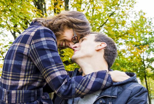 Portrait of love couple embracing outdoor looking happy