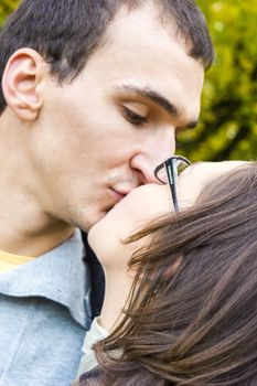 Love couple closeup kissing looking happy