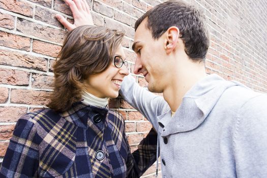 Portrait of love couple looking happy against wall background