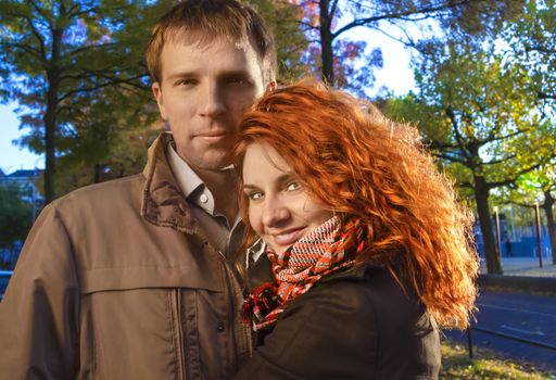 Outdoor happy couple in love posing against autumn Amsterdam background