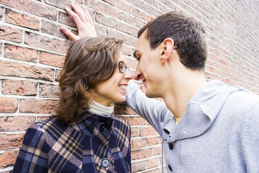 Portrait of love couple looking happy against wall background