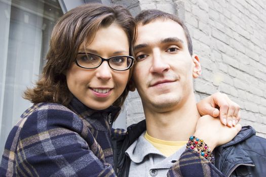 Portrait of love couple embracing outdoor in park looking happy