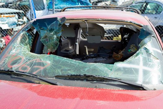 Detail of a vehicle at the auto salvage yard after a major accident collision.