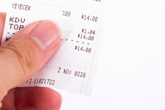 Close up view of hand holding cash register receipt, isolated on white background.