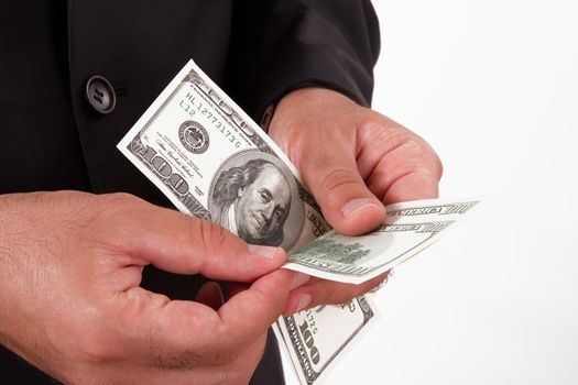Man couns money in hands, hundred of dollars, isolated on white background.